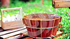 Wooden bucket for foot bath in hot spring garden, onsen, soft-focus.4k