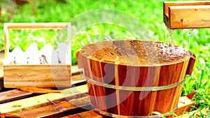 Wooden bucket for foot bath in hot spring garden, onsen, soft-focus.4k