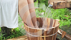 Wooden bucket for foot bath in hot spring garden, onsen, soft-focus.4k