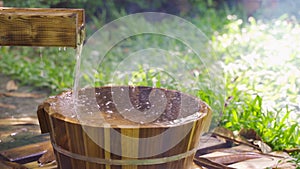 Wooden bucket for foot bath in hot spring garden, onsen, soft-focus.4k