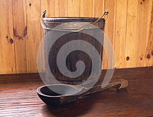 A wooden bucket and a spoon. Bath accessories