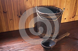 A wooden bucket and a spoon. Bath accessories