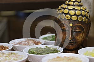 Wooden buddha statue and food spices