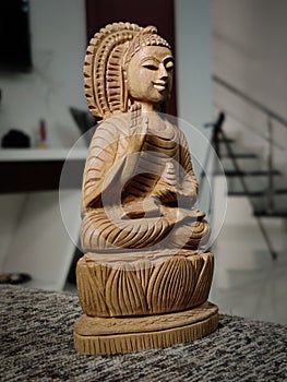 WOODEN BUDDHA STATUE IN LUMINANCE LIGHTING