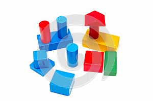 Wooden building blocks shaped like a cube, cylinder, prism and triangle of red, green, blue, green and yellow color. Isolated on