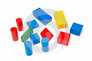 Wooden building blocks shaped like a cube, cylinder, prism and triangle of red, green, blue, green and yellow color. Isolated on