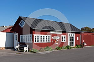 Wooden building in the Danish harbor of Harboelle Havn at the island Moen