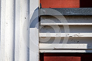 Wooden building details and construction. Red and white color. Metal parts