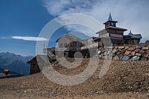 Wooden building and snow cannon in the mountains in summer