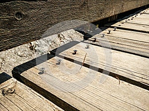 Wooden buildings. Detail with screws torn off the floorboards of an old wooden deck