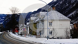 Wooden buildings in winter near road