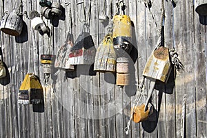 Wooden buoys hanging on fence