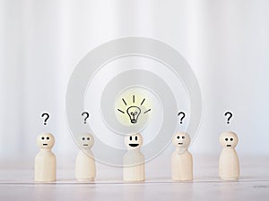 Wooden business figure with light bulb and question mark for leadership, creative, idea, innovation concept