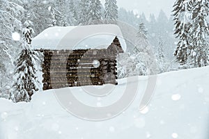 Wooden cabin in the austrian alps, covered with snow