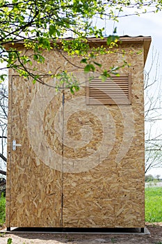 Wooden cabin in the garden for taking a summer shower. Construction