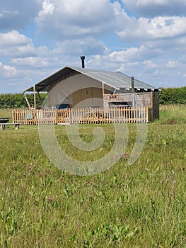 Wooden cabin at a glamping site in the countryside