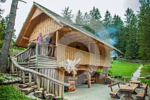 Wooden cabin with tourists at Hija Glamping Lake Bloke in Nova Vas, Slovenia photo