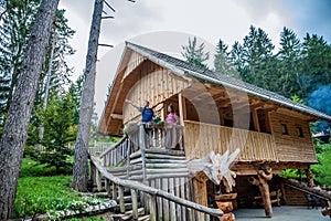 Wooden cabin with tourists at Hija Glamping Lake Bloke in Nova Vas, Slovenia photo