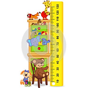 Wooden cabinet with toys measure the child growth