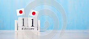 Wooden calendar of February 11th with miniature Japan flags. National Foundation Day,  New Year`s Day in the traditional lunisola