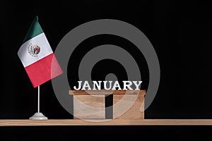 Wooden calendar of January with Mexico flag on black background. Holidays of Mexico in January