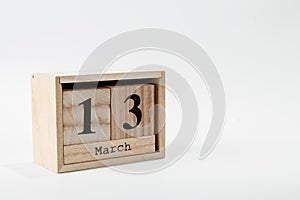 Wooden calendar March 13 on a white background