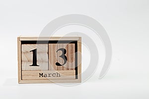 Wooden calendar March 13 on a white background