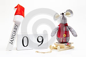 Wooden calendar with number January 9. Happy New Year! Symbol of New Year 2020 - white or metal silver rat. Christmas decorated
