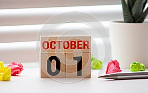 Wooden calendar October 01 on a white background close up