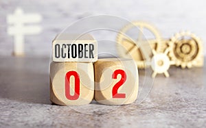 Wooden calendar October 02 on a white background close up