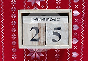 Wooden calendar on the table with 25 of December on it. Holidays and celebration concept, greeting card mockup