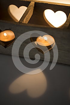 Wooden candlestick with notches in the shape of hearts