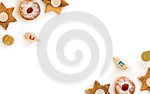 Wooden candlesticks in the shape of star, donuts, golden chocolate coins and wooden dreidels on white background