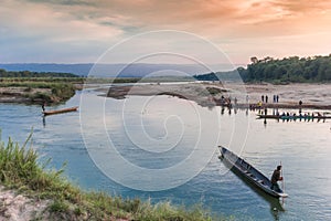 Wooden canoes crossing the river in Chitwan National Park