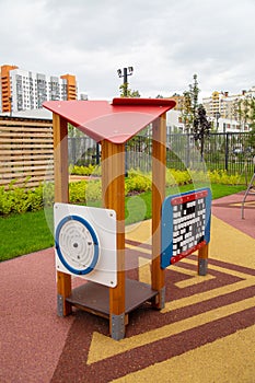 Wooden canopy with toys with a beautiful rubberized coating in the form of triangles on the playground