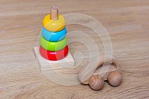 Wooden Car and stacking toy. Development games for children. Colorful pyramid and simple automobile