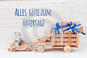 Wooden car with teddy bear and wooden truck with gifts. German g