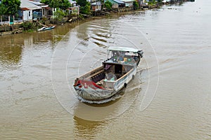 Wooden cargo boat on the Mekong River Delta