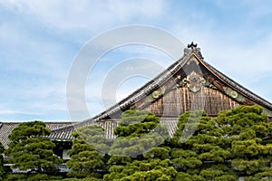 Wooden carved Nijo Castle roof in Kyoto with golden decorations and detailed artwork, Kyoto, Japan.