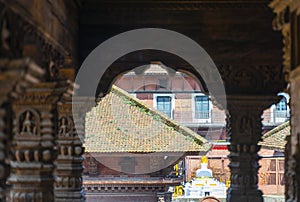 Wooden carved pillars and view through the arch in the temple of Durbar square at Patan Kathmandu, Nepal