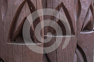 Wooden carved posts on the street, old-style log fence