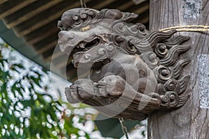 Wooden carved Shishi Lion Nosing ornament of Chozuya or Temizuya (Water ablution pavilion) at Suzukamyo Shrine