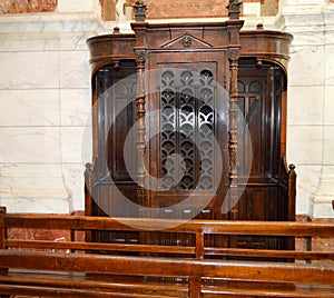 Wooden carved window of the confessional in the Church