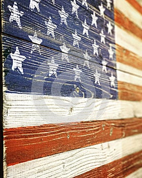 A wooden carving of Old Glory hangs on a wall