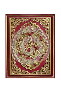Wooden carving sclupture of golden partner dragon among of flowers and painted on red wooden tray isolated on white backgrounds