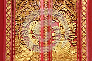 Wooden carving sclupture of Ramakien Performance in the middle of heaven forest decorated with gold leaf and red painting