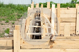 Wooden casing for strip footing tape foundation