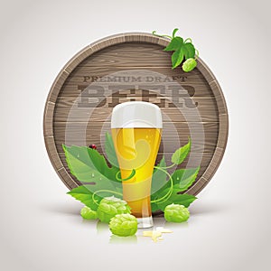 Wooden cask, beer glass, ripe hops and leaves photo