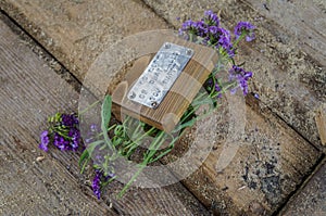 Wooden casket with flowers on a wooden background with sawdust