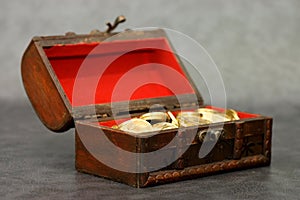 Wooden casket full of coins